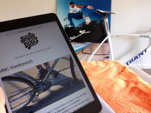 Skate or Bikes web site displayed on an iPad with an big photo of Sal Barbier skateboarding and a frame in the same room.